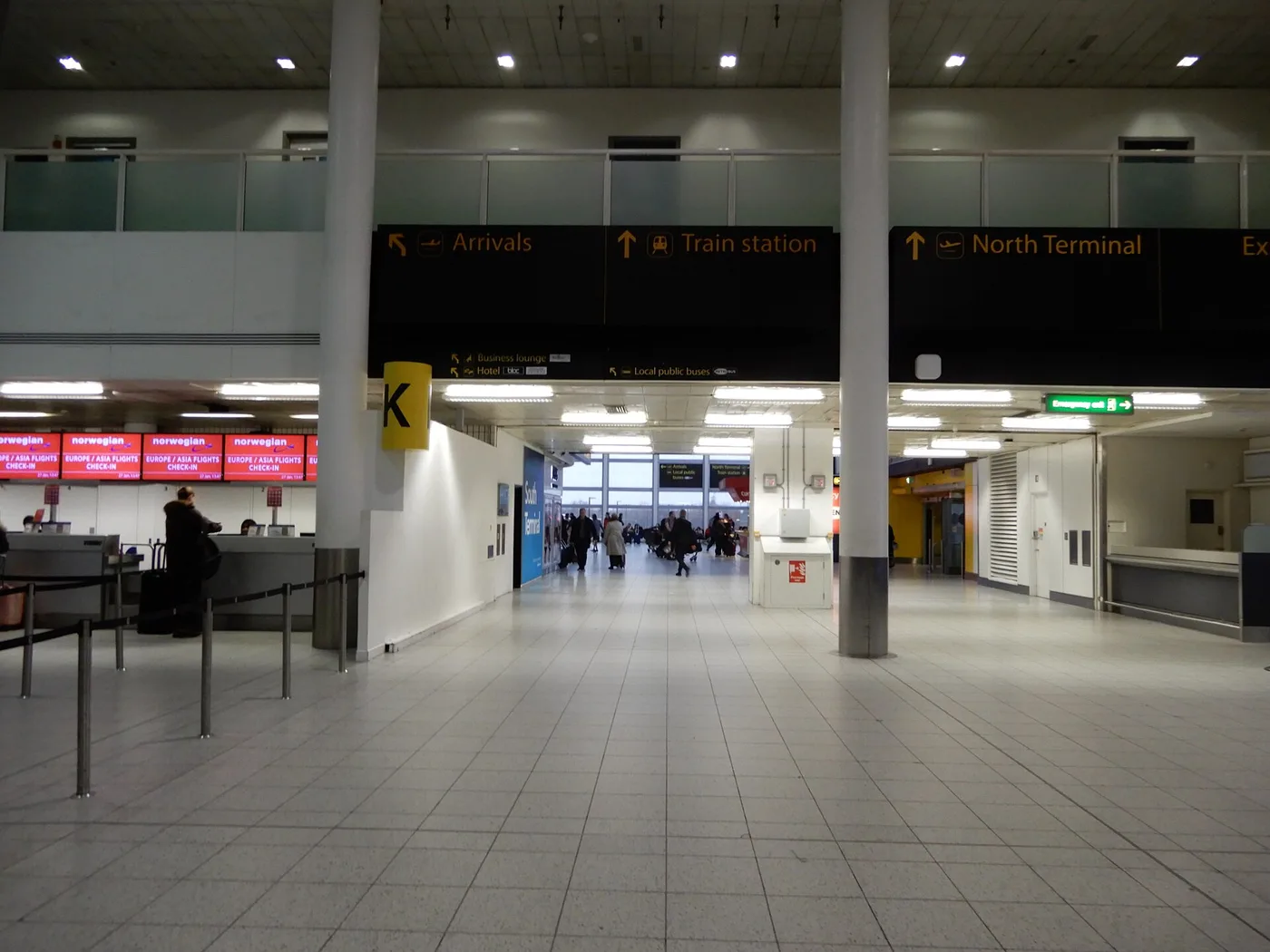 Wayfinding signs to the train station and North Terminal inside Gatwick Airport